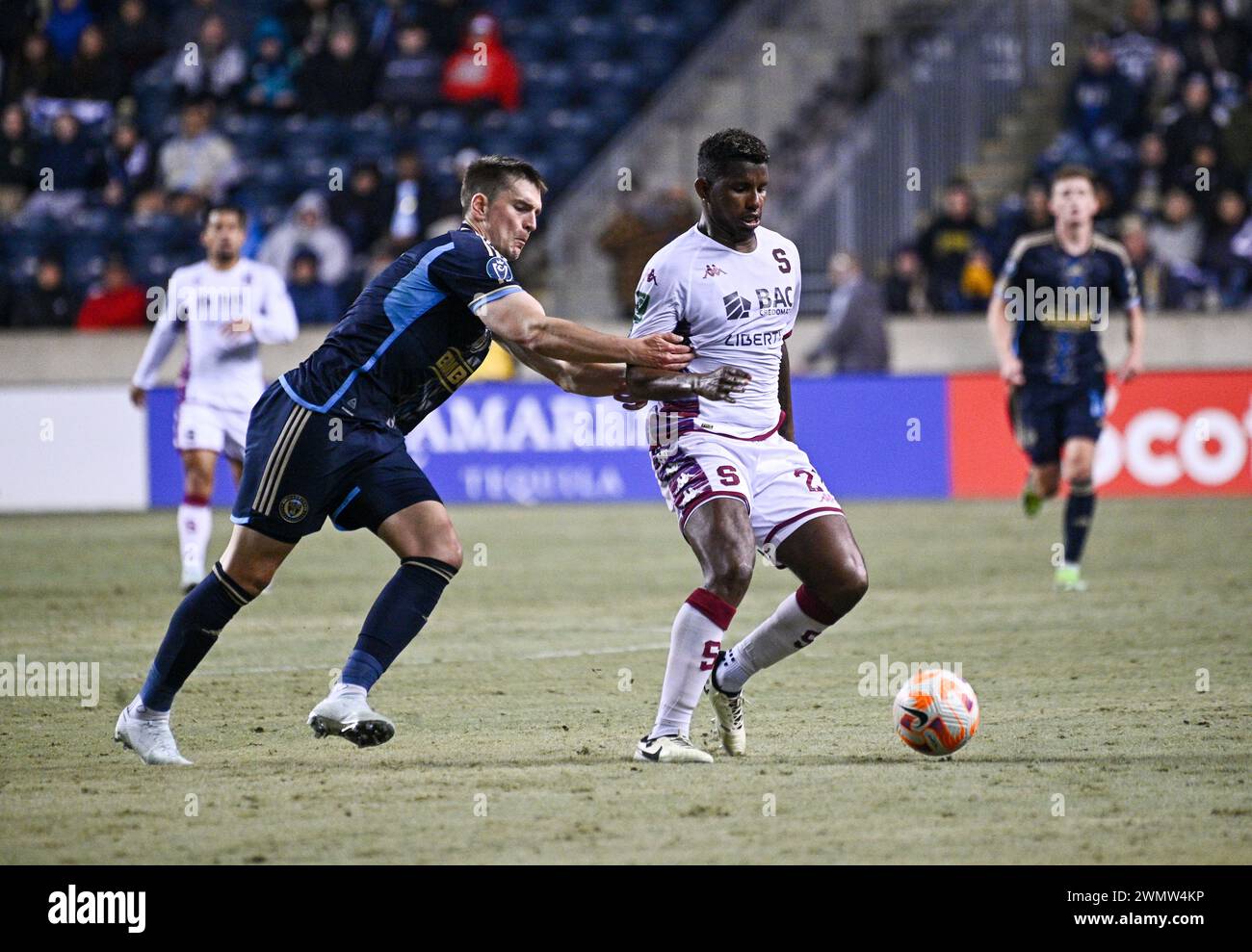 Chester, Pennsylvania, USA. 27th Feb, 2024. February 27, 2024, Chester PA, USA: Deportivo Saprissa player, FIDEL ESCOBAR (21) fights for the ball with Philadelphia Union player, MIKAEL UHRE (7) Union at the 2024 Concacaf Champions Cup Round One at Subaru Park. The Union won on aggregate points to move into the round of 16. Credit Image: © Ricky Fitchett via ZUMA Wire (Credit Image: © Ricky Fitchett/ZUMA Press Wire) EDITORIAL USAGE ONLY! Not for Commercial USAGE! Stock Photo