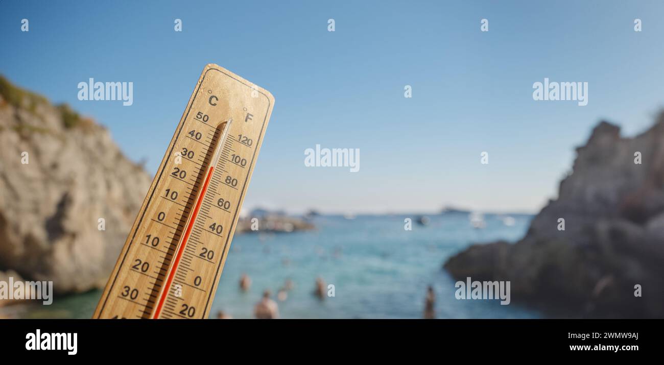 Wooden thermometer with red measuring liquid showing high temperatures
