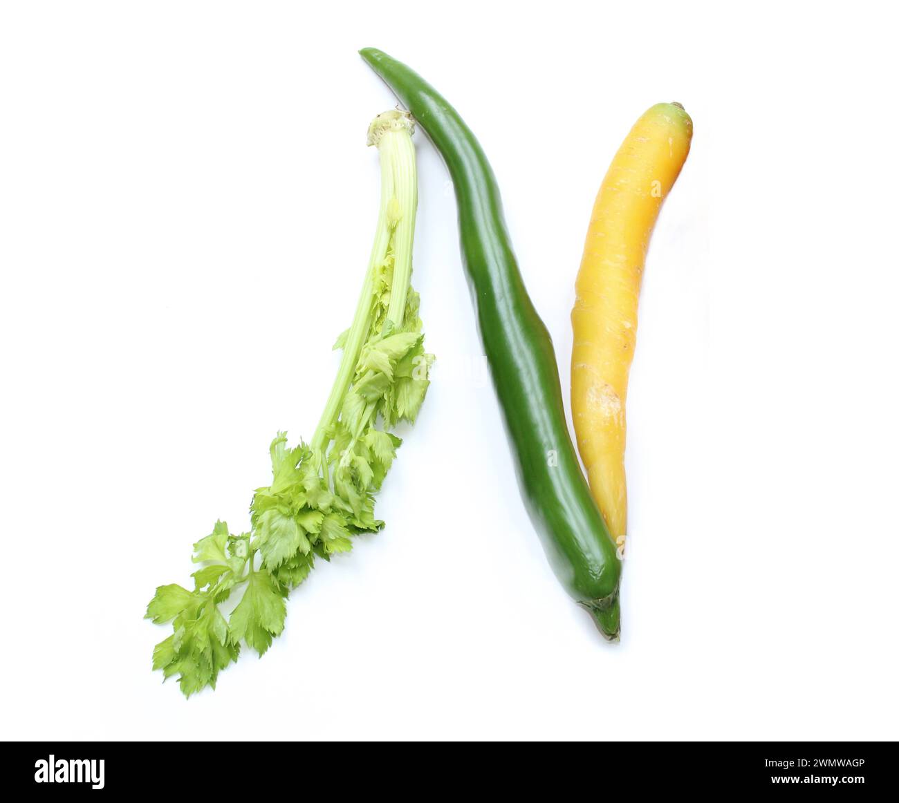 letter n from a yellow carrot, green chili pepper, celery for alphabetic ABC letters made of chillies, vegetables, texts, recipes, cookery book Stock Photo
