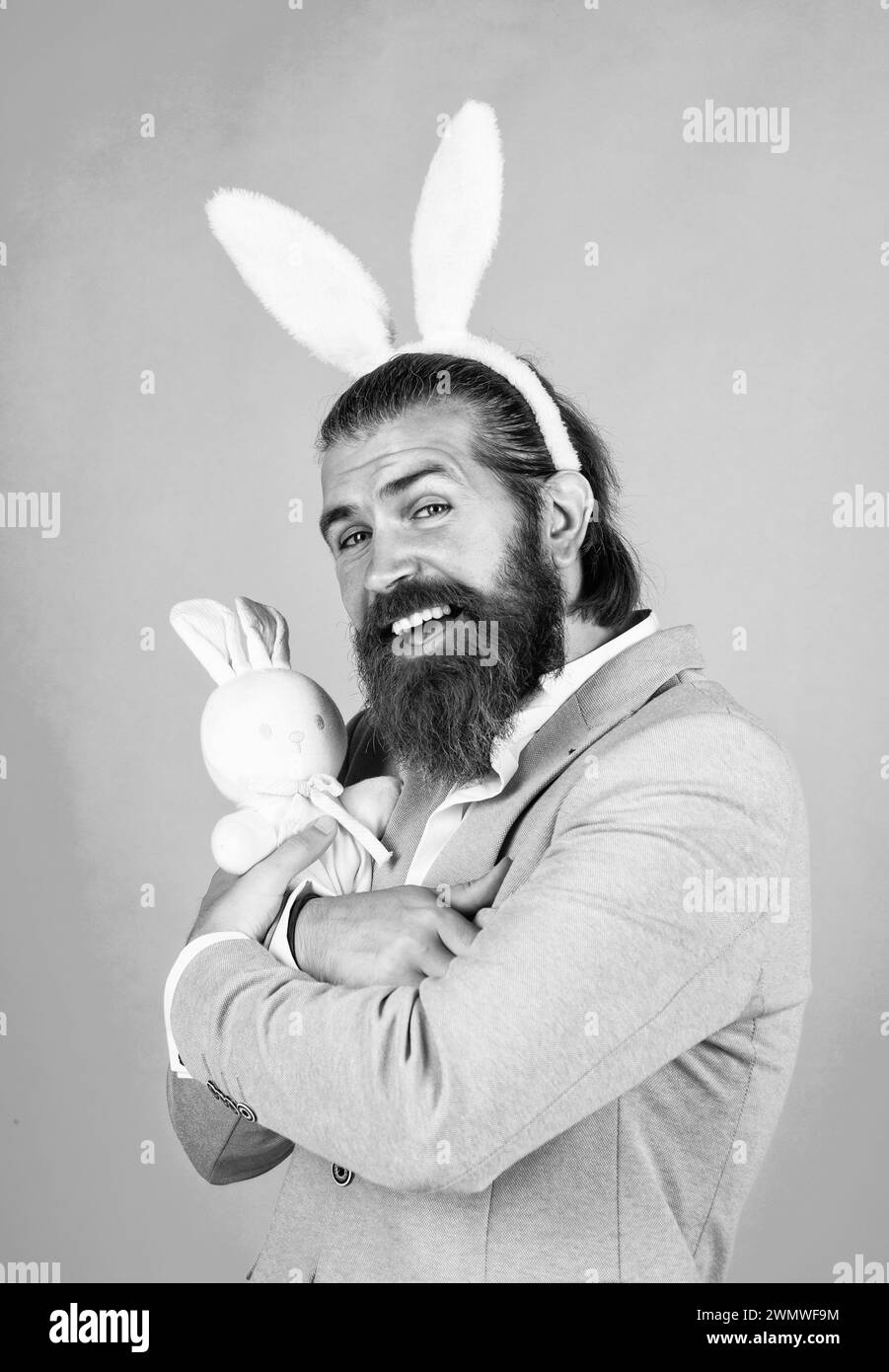 mature bearded male guy looking elegant wearing bunny ears, easter ...