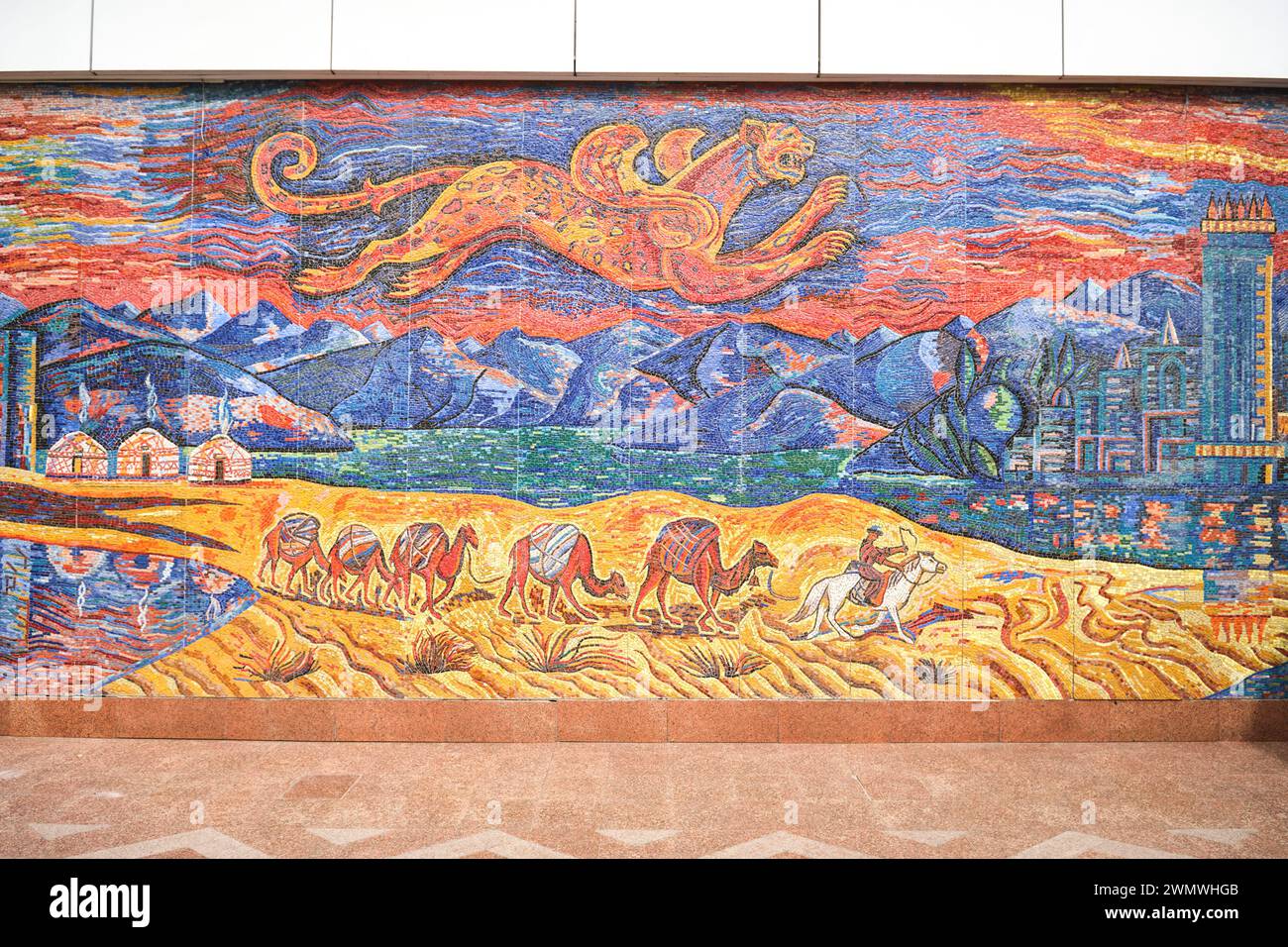 The large, colorful tile mosaic that depicts a camel caravan, traveling between the rural, old Silk Road to the modern, skyscraper city. At the front Stock Photo