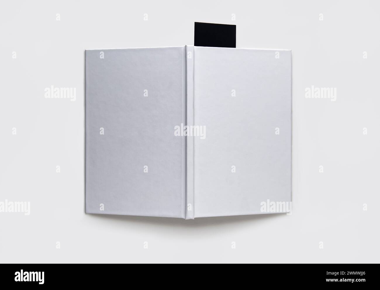 A blank book with a black bookmark on a white background Stock Photo