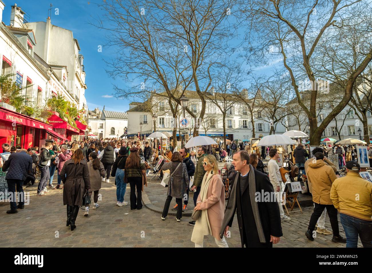 Paris, France - February 17, 2024 : View of the busy and picturesque Montmartre area, famous for artists and restaurants in Paris France Stock Photo