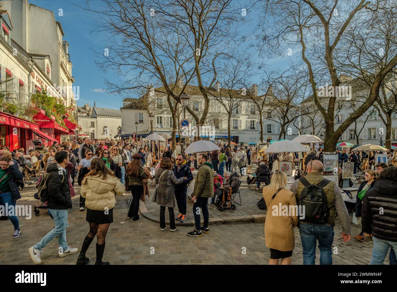 Paris, France - February 17, 2024 : View of the busy and picturesque Montmartre area, famous for artists and restaurants in Paris France Stock Photo