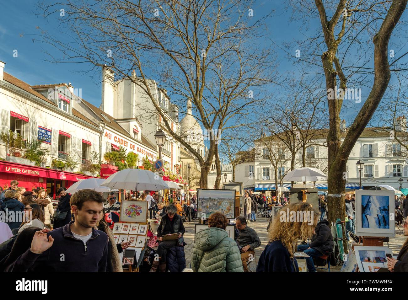Paris, France - February 17, 2024 : View of the busy and picturesque Montmartre area, famous for artists and restaurants in Paris France Stock Photo