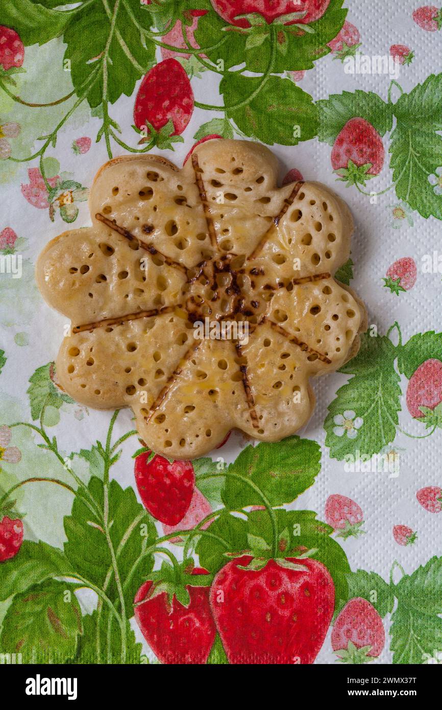 Blooming Lovely Crumpet light fluffy flower shaped crumpet from M&S on serviette napkin Stock Photo