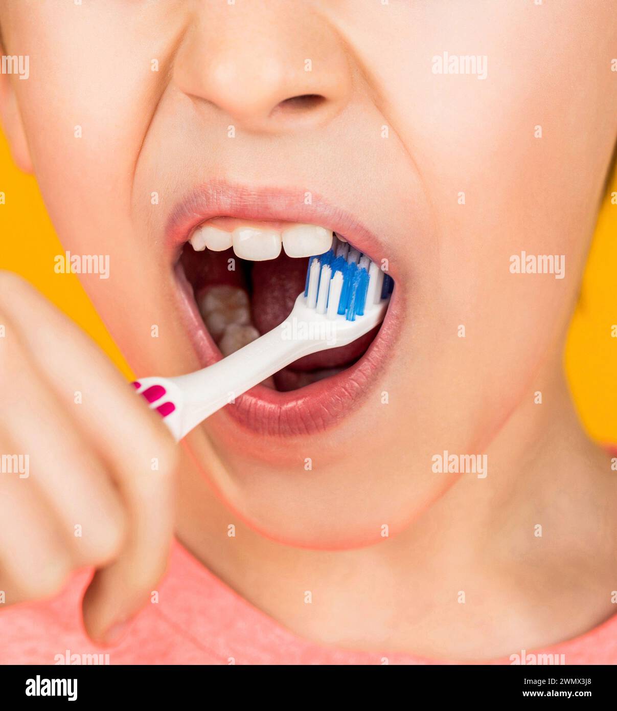 Little kid brushing her teeth. Kid boy brushing teeth. Boy toothbrush white toothpaste. Child shows toothbrushes. Little boy cleaning teeth Stock Photo