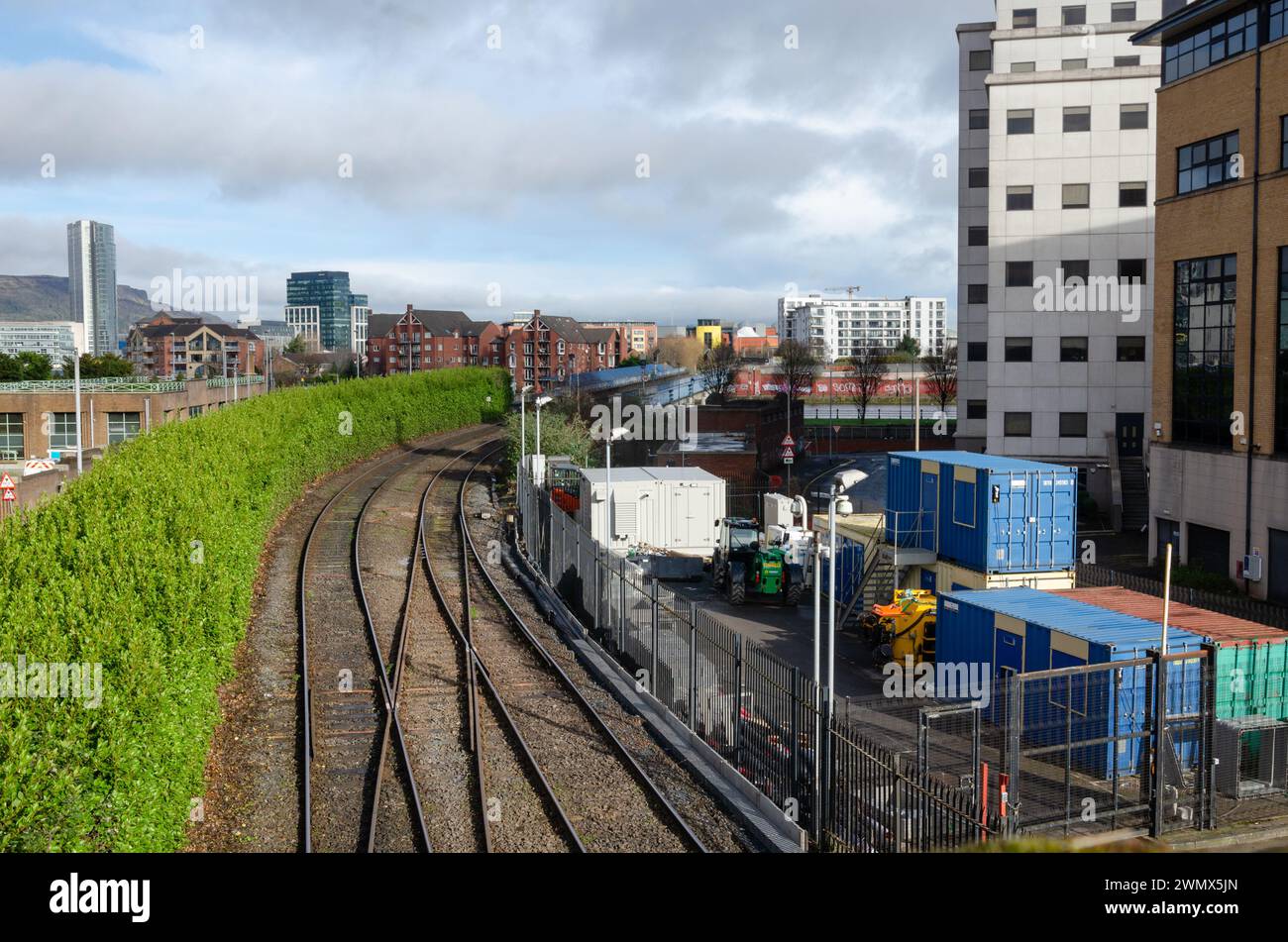 Belfast County Antrim Northern Ireland February 23 2024 - Railway tracks going to the station at Lanyon Place with city skyline behind Stock Photo