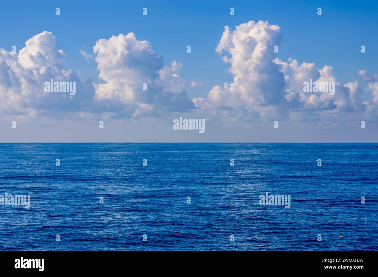 Vast blue ocean under a sky with fluffy white clouds, in South Korea ...