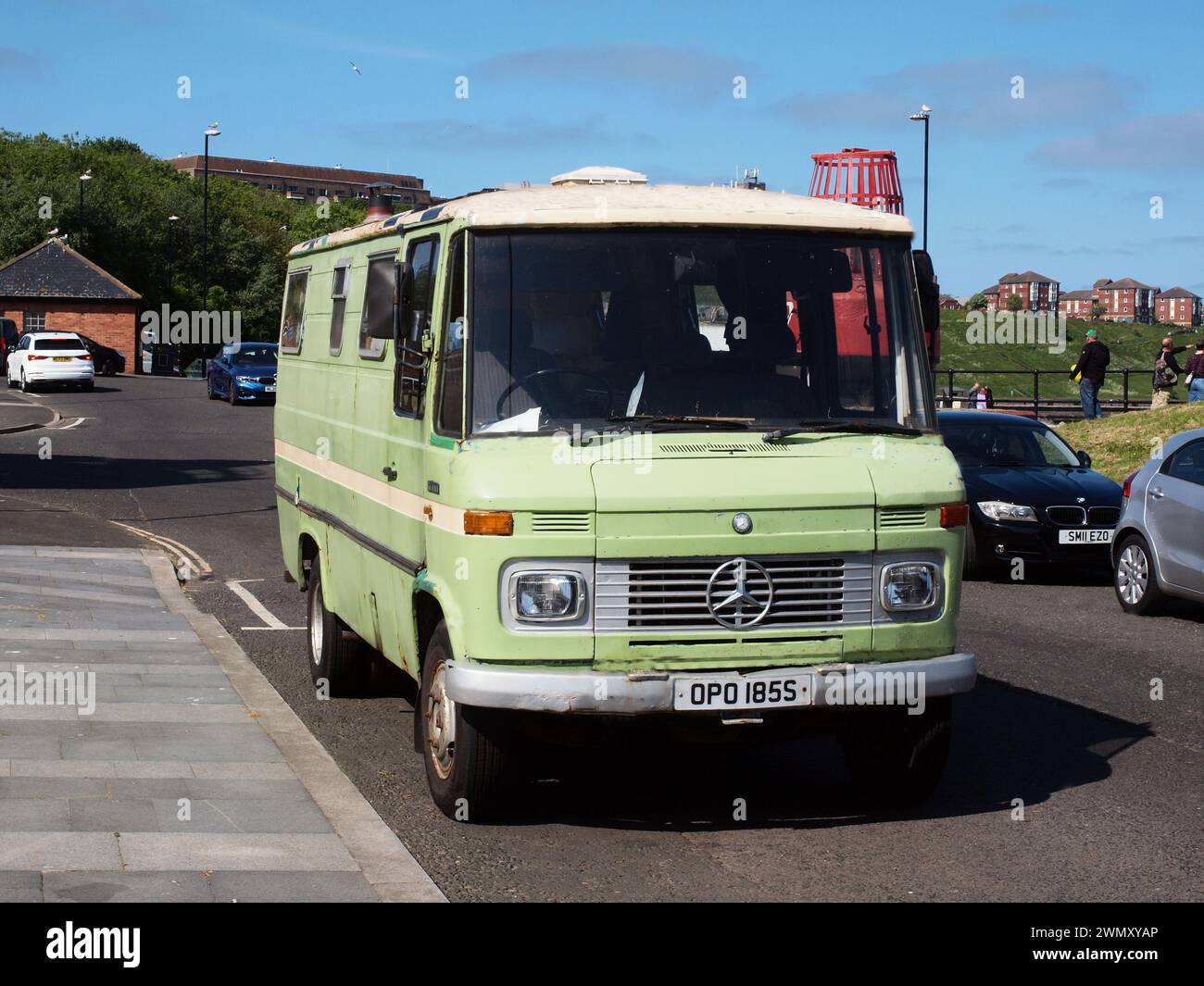A 1977 lime green 'Mercedes Benz 608D' camper van with a distinctive  smoke stack protruding through the roof of the vehicle . Stock Photo