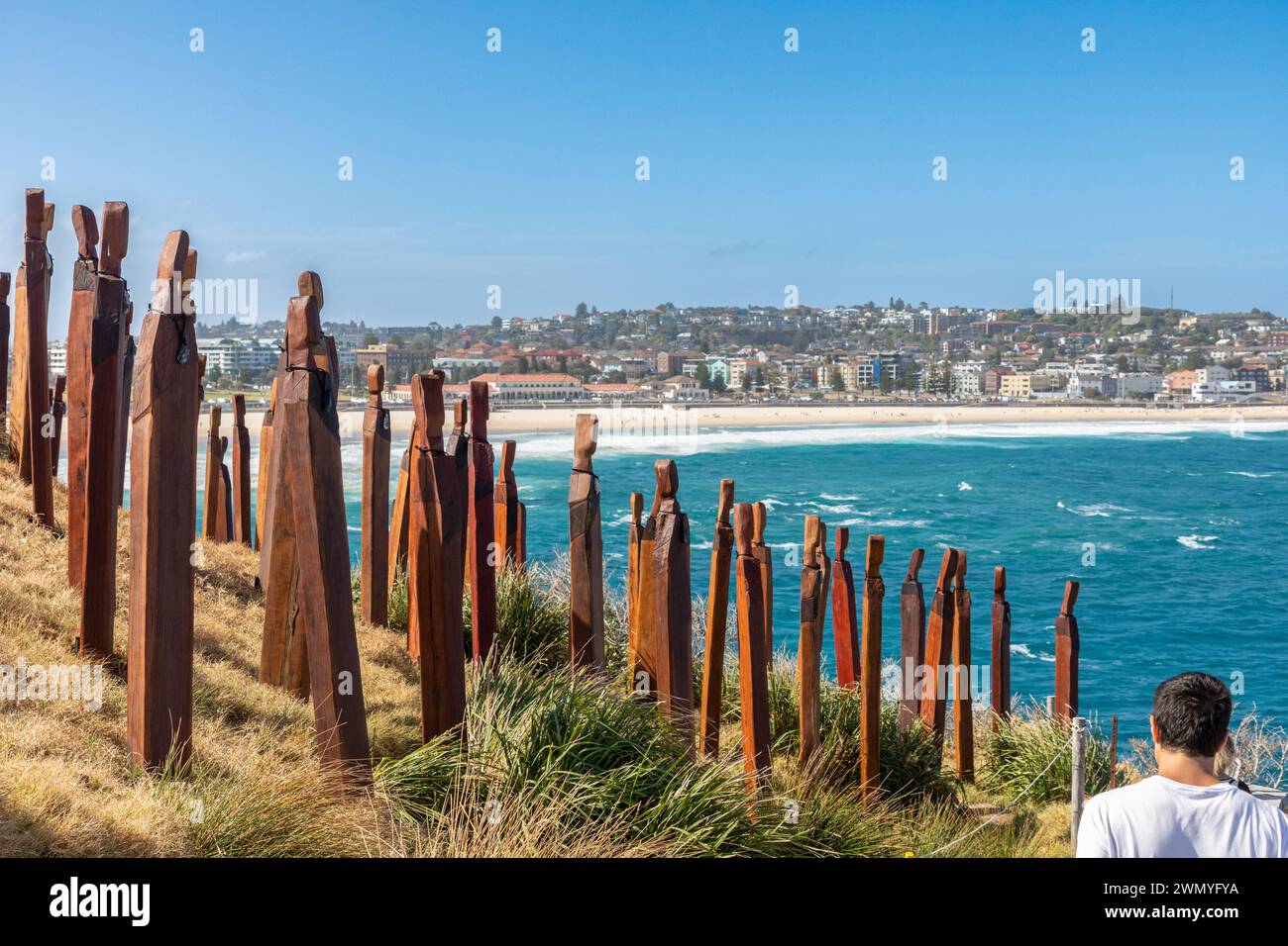 Visitors pass 'Papare/Protection' by Anton Forde, part of the 'Sculpture by the Sea' exhibit on the coastal walk between Bondi and Tamarama beaches. Stock Photo