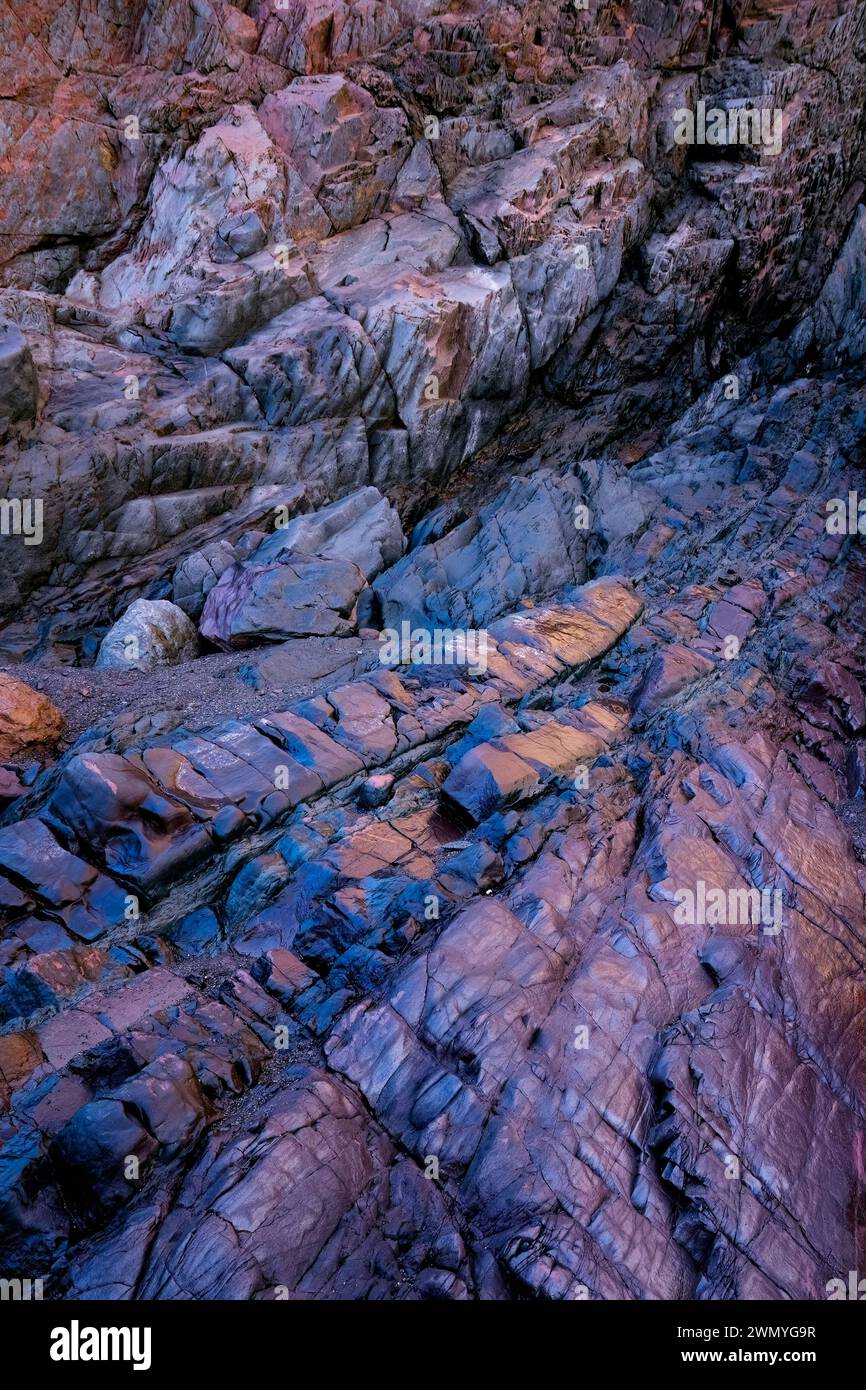 Striking rock formations at the beach of the old mine of Llumeres, in Asturias, with patterns created by biofilm bacteria rich in iron. Stock Photo
