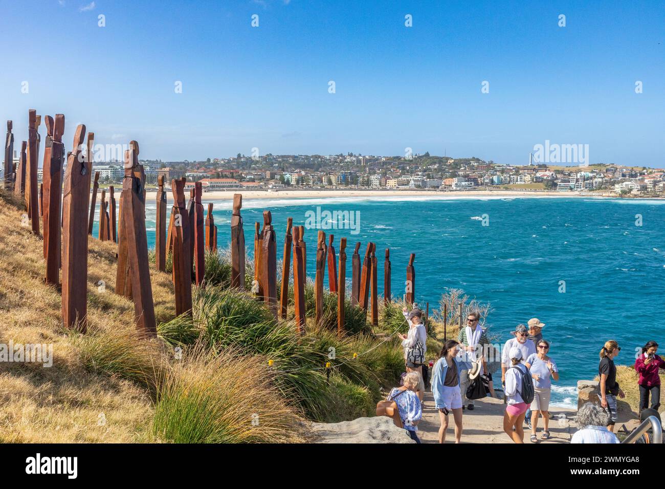 Visitors pass 'Papare/Protection' by Anton Forde, part of the 'Sculpture by the Sea' exhibit on the coastal walk between Bondi and Tamarama beaches. Stock Photo