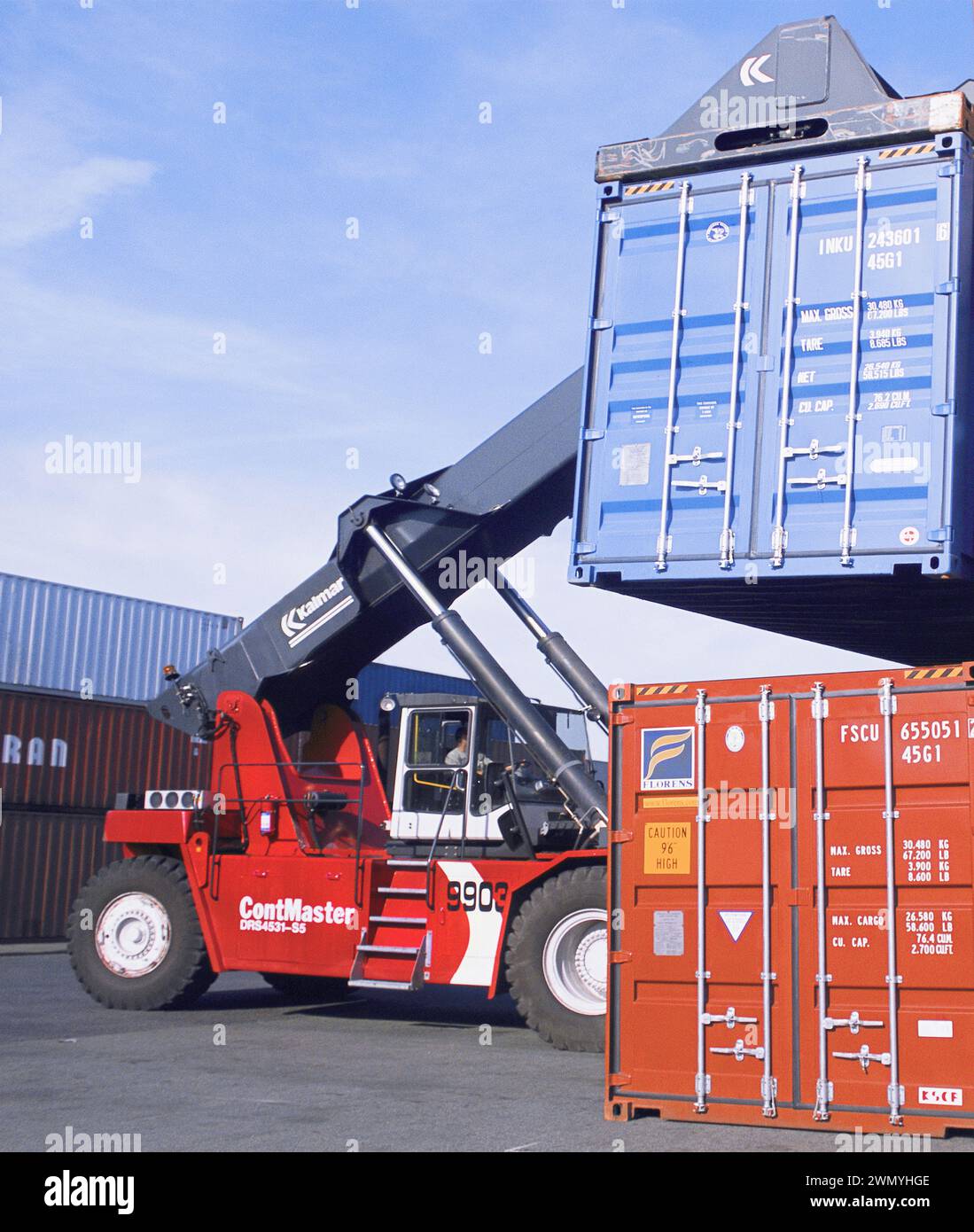 Forklift container. Forklift truck stacking shipping containers at Port