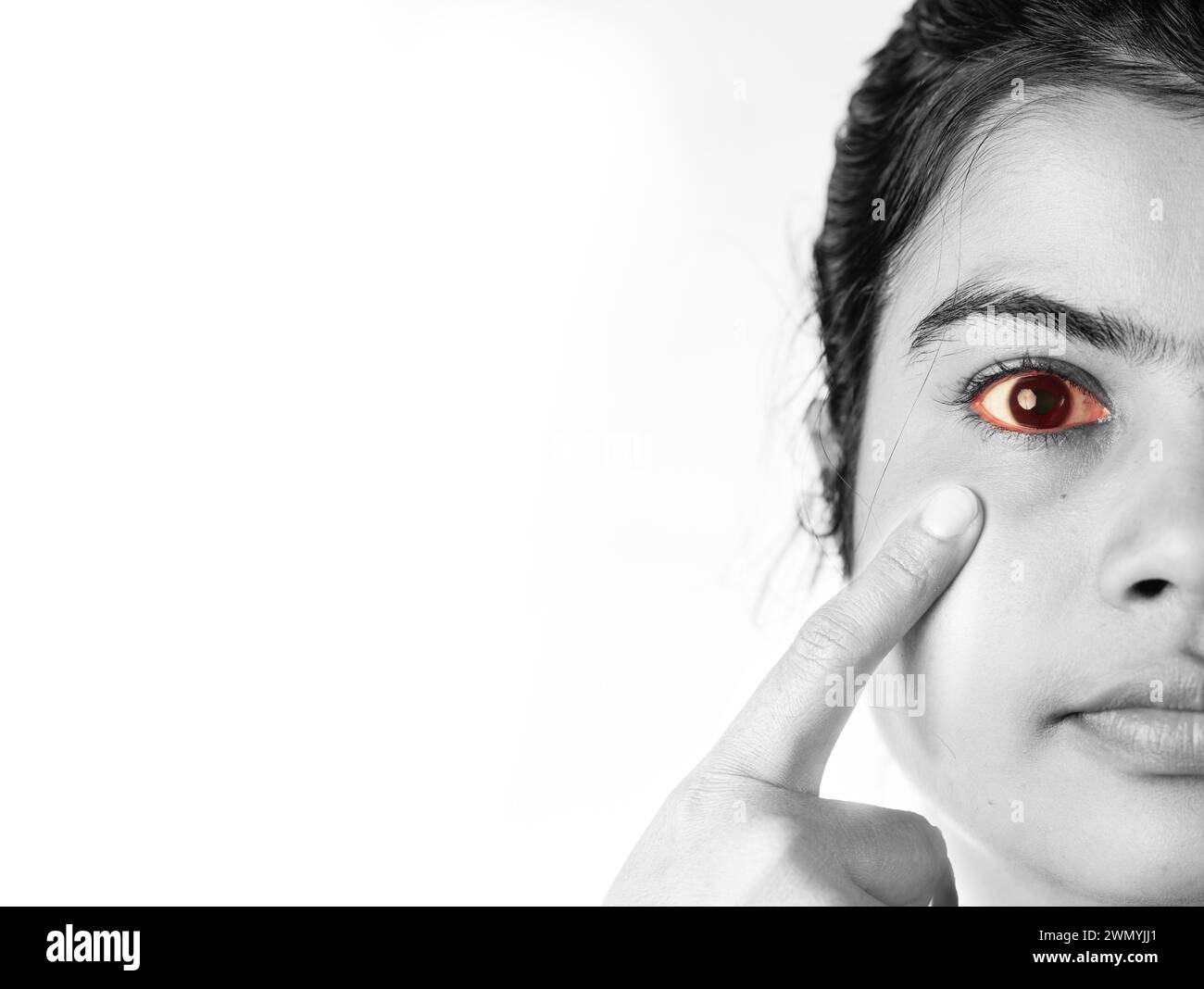 Close up monochrome view of yellow reddish eye of an Indian female