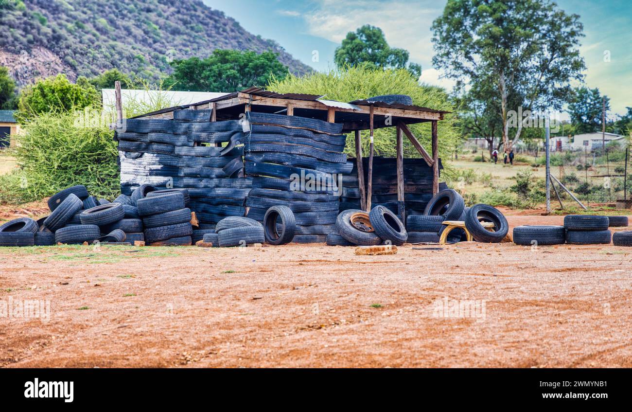 township informal settlement in africa near a hill, shack made out of tires Stock Photo