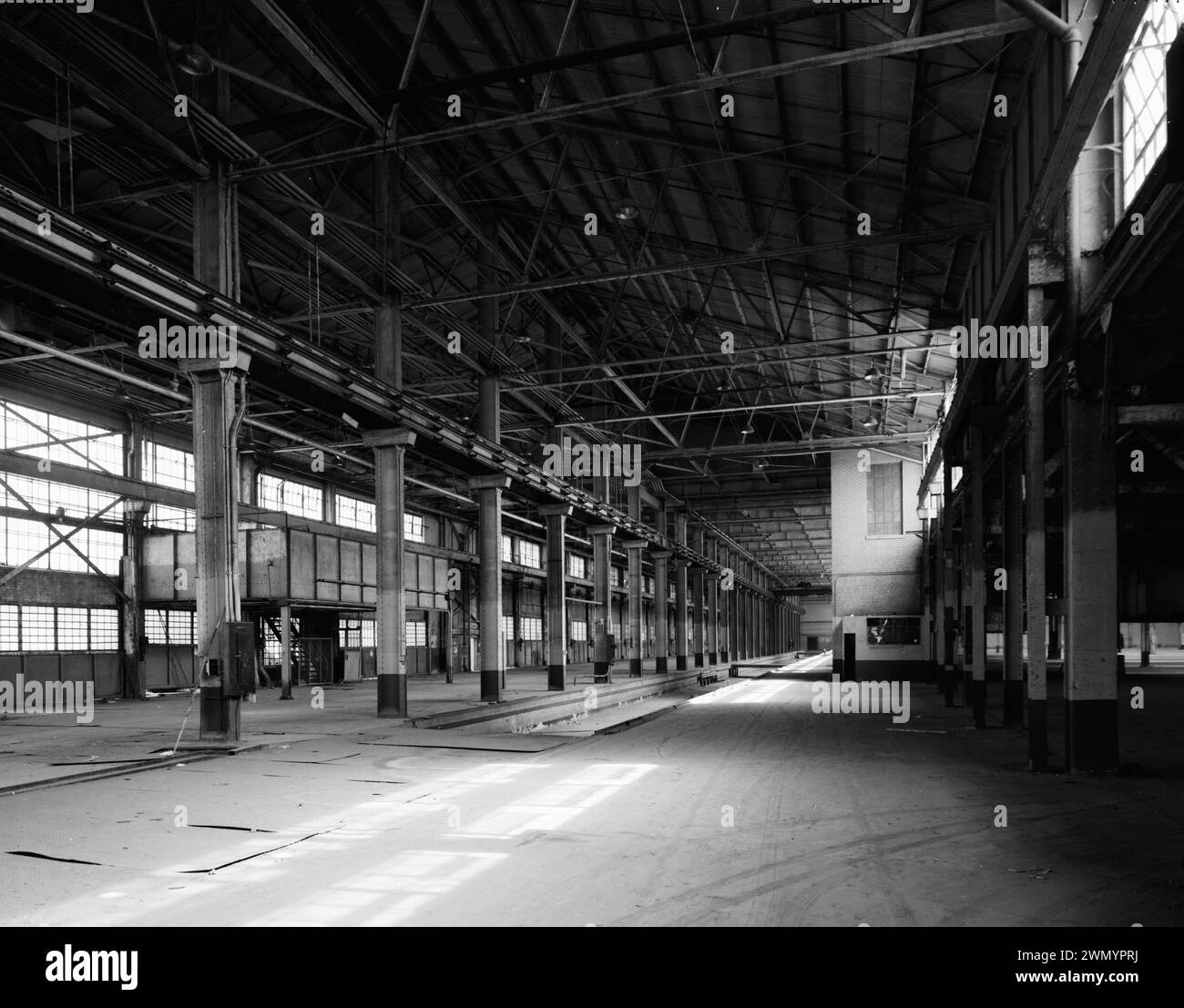 Industrial area - vintage building - Warehouse -  LOOKING SOUTH-SOUTHEAST ALONG SUNKEN RAIL SPUR TO BOILER ROOM AND FREIGHT ELEVATOR. - Ford Motor Company Long Beach Assembly Plant, Assembly Building, 700 Henry Ford Avenue Stock Photo
