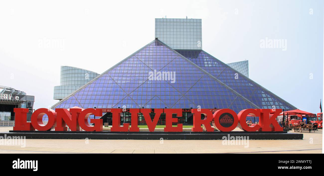 Cleveland, Ohio, USA - 2 August 2023: The bold red Long Live Rock sign stands prominently in front of a striking blue glass pyramid building, symboliz Stock Photo