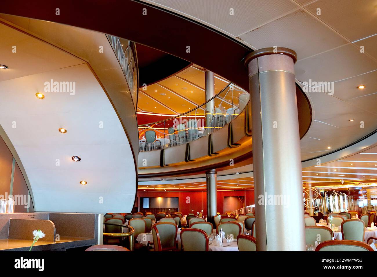 Sweeping staircase linking the two levels of the Meridian restaurant MDR (Main Dining Room) situated aft aboard the P&O cruise ship Arcadia. Stock Photo