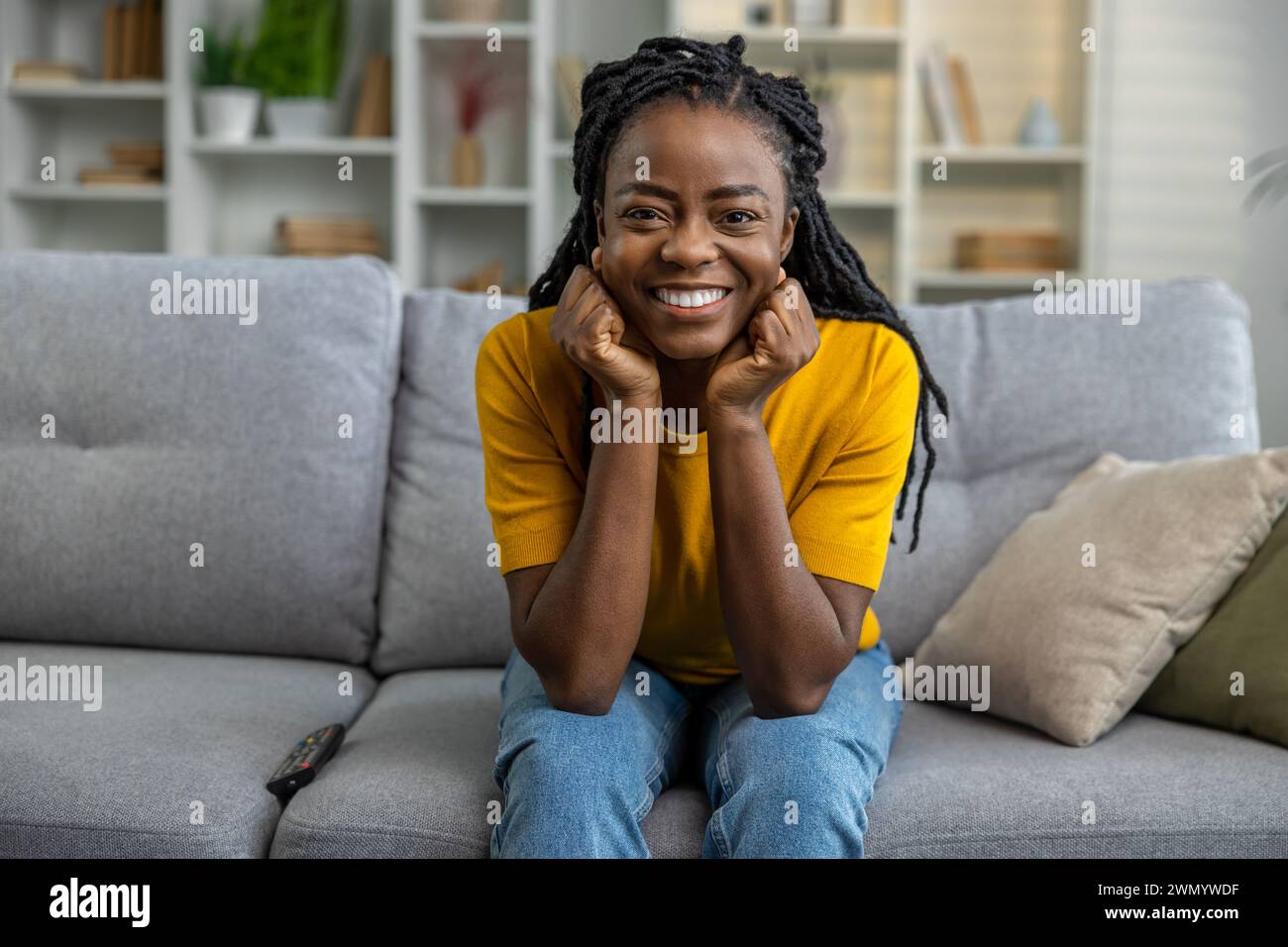 Cute smiling african american woman looking contented Stock Photo - Alamy