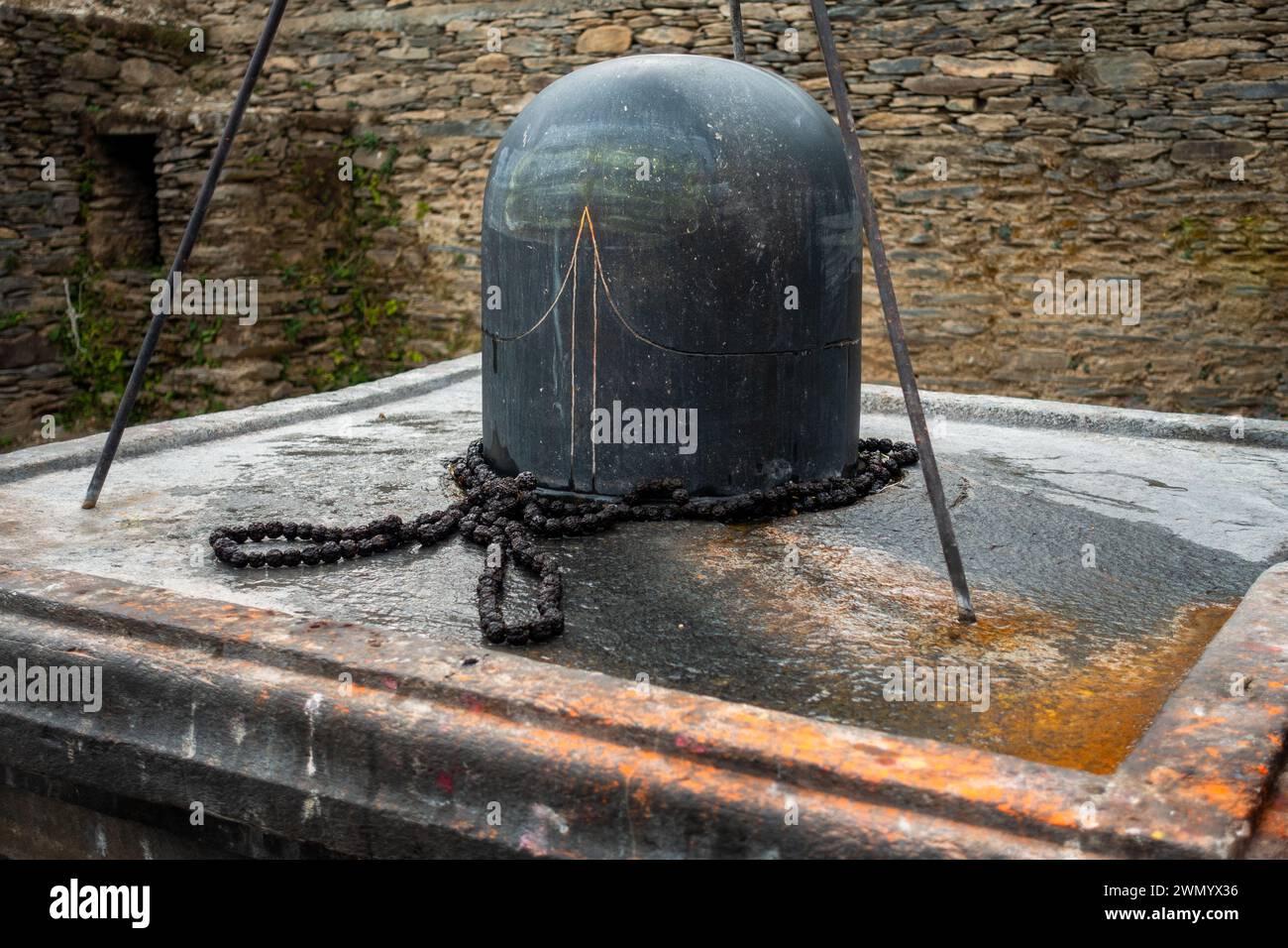 Feb.18th 2024, Uttarakhand India. Granite stone Shivalinga's at Lakhamandal Shiva Temple. It shines like a mirror and reflects the surrounding view. Stock Photo