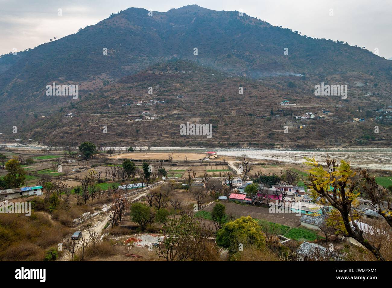 Cinematic Shot: Pyramid-Shaped Mountains with Riverside Village, Uttarkashi, Uttarakhand, India Stock Photo