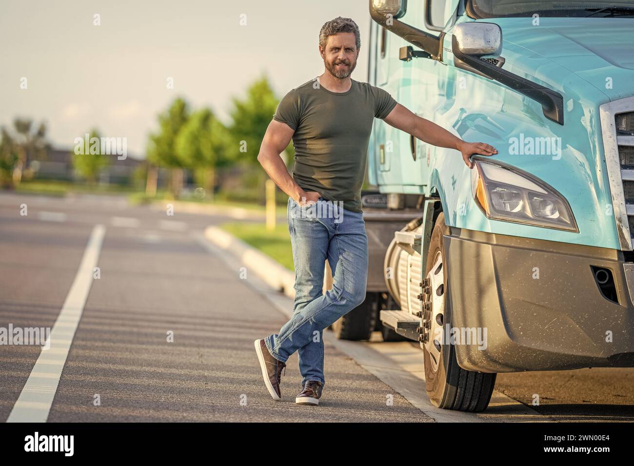 Trucking owner hispanic man at transportation vehicles driver near lorry taking a break. Stock Photo