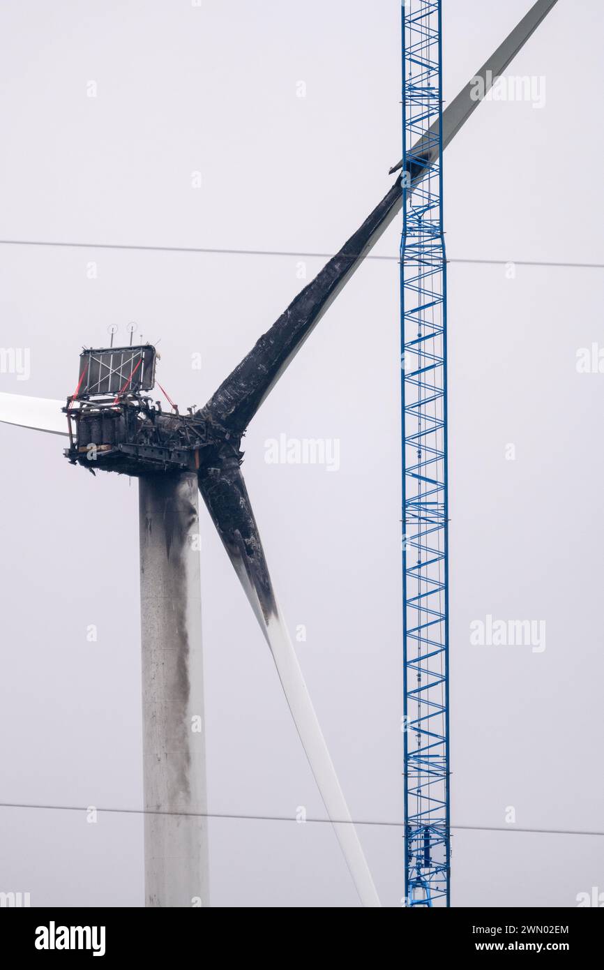 Greifswald, Germany. 28th Feb, 2024. A crane is set up on a wind turbine to dismantle the wind turbine near Greifswald that was destroyed by fire. On Tuesday (23.01.2023), a wind turbine near Greifswald caught fire. The fire department had to let the nacelle burn down in a controlled manner. According to the police, technical defects were the cause. Credit: Stefan Sauer/dpa/Alamy Live News Stock Photo