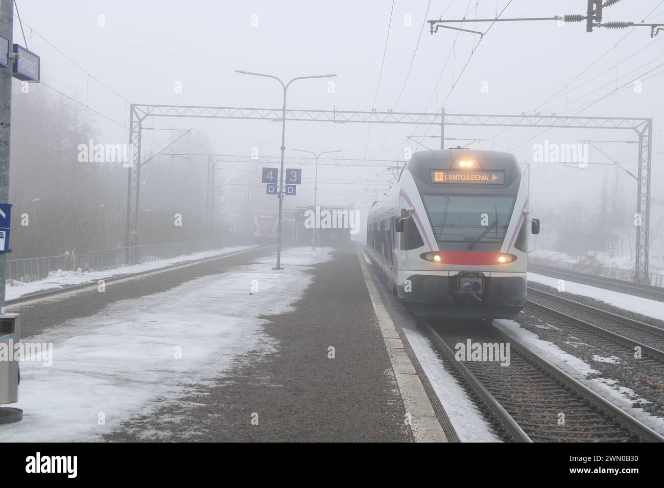 Foggy winter day in Finland. Trains and buildings in the fog Stock Photo