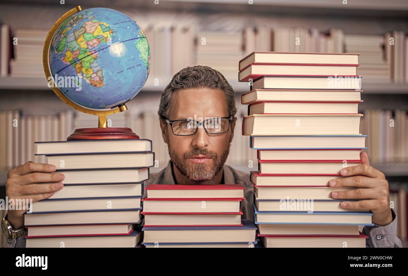 Knowledge and education concept. school teacher with book in classroom ...