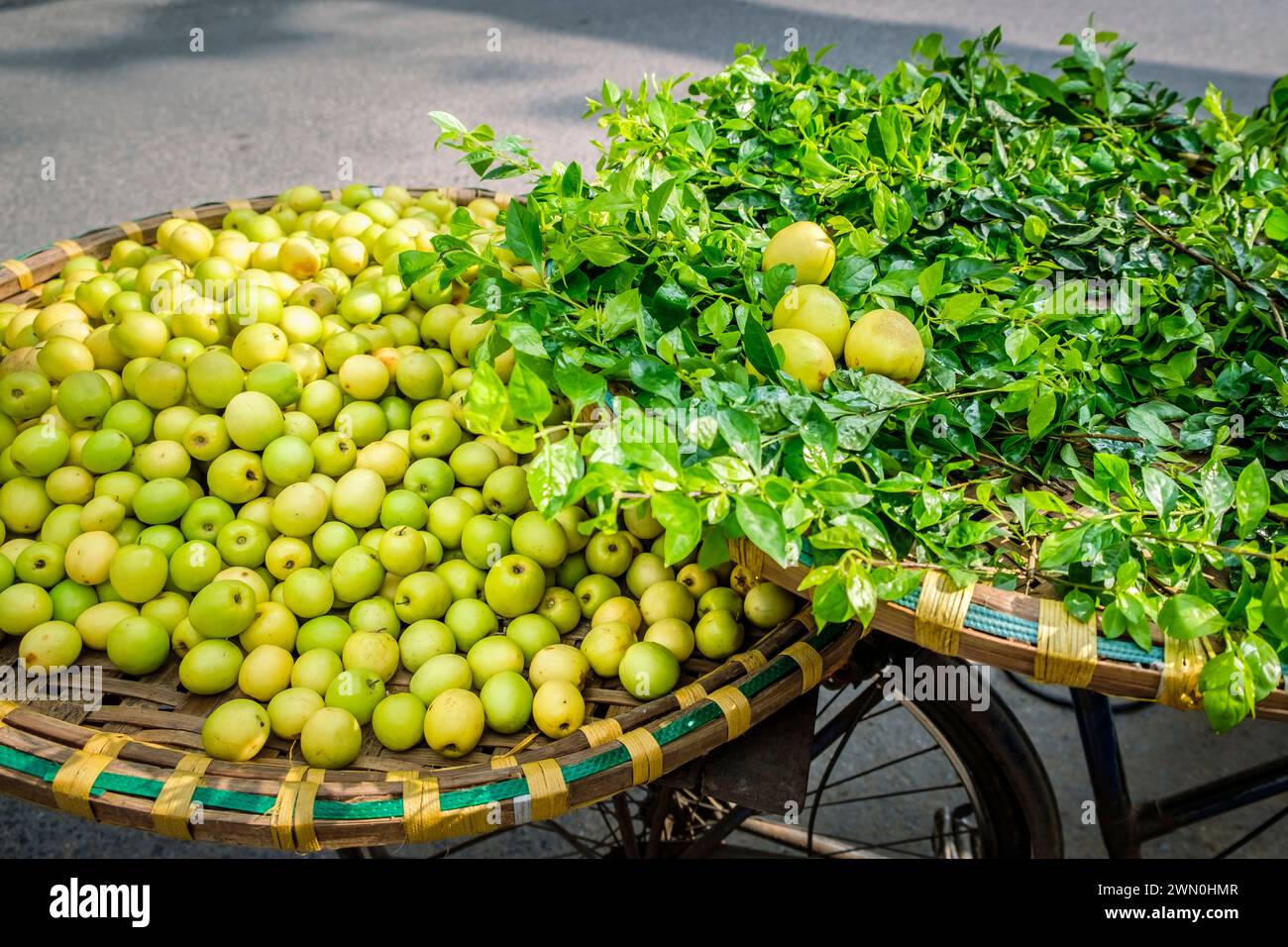 Fresh apples for sale from the back of a bicycle on the street in Hanoi, Vietnam Stock Photo