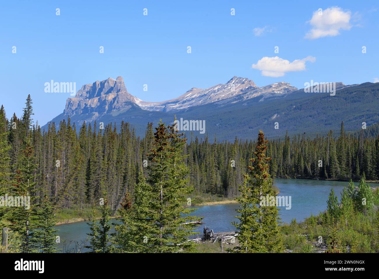 The Bow River winding past Castle Mountain in the Rocky Mountains in Alberta Canada Stock Photo