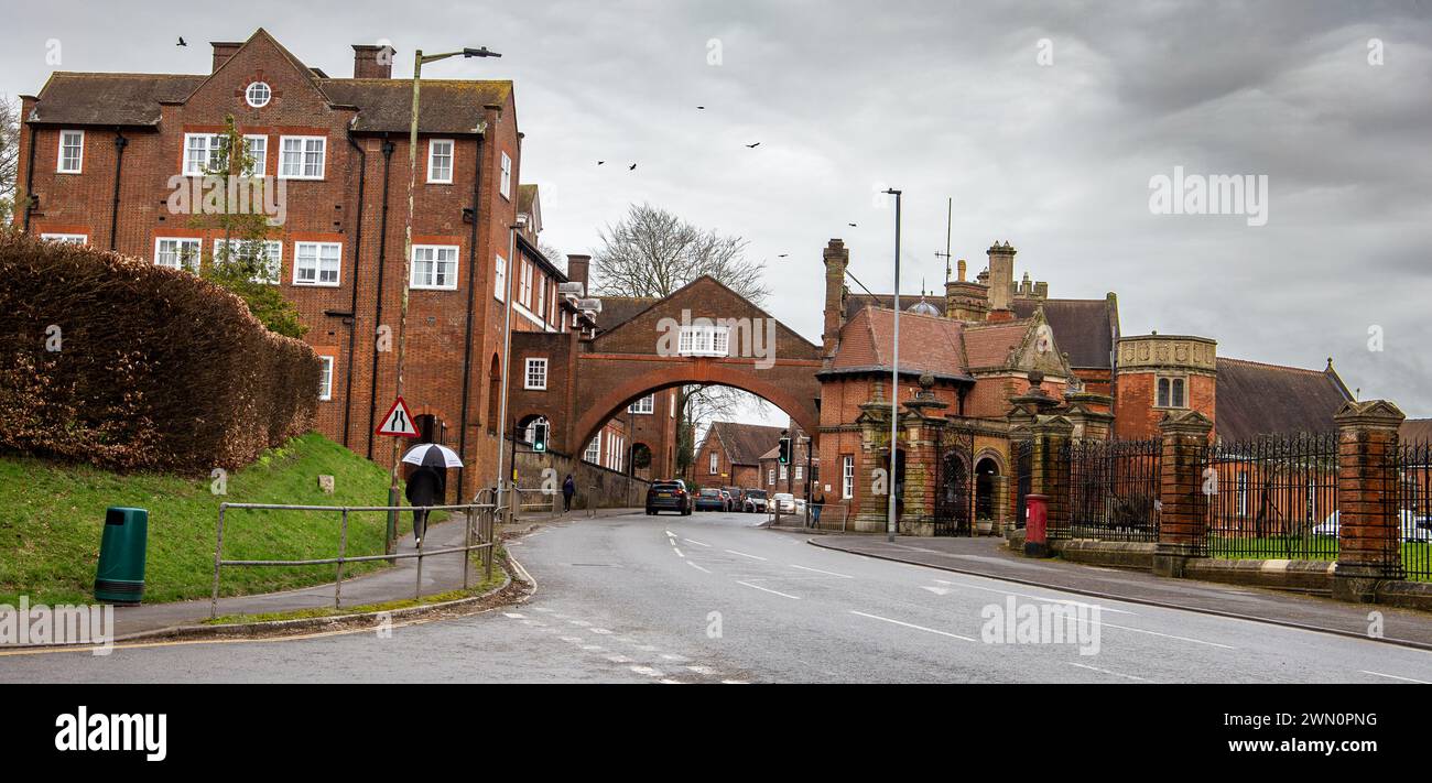 Marlborough college buildings private boarding and day school with archway across the road and traffic flowing underneath Wiltshire UK Stock Photo