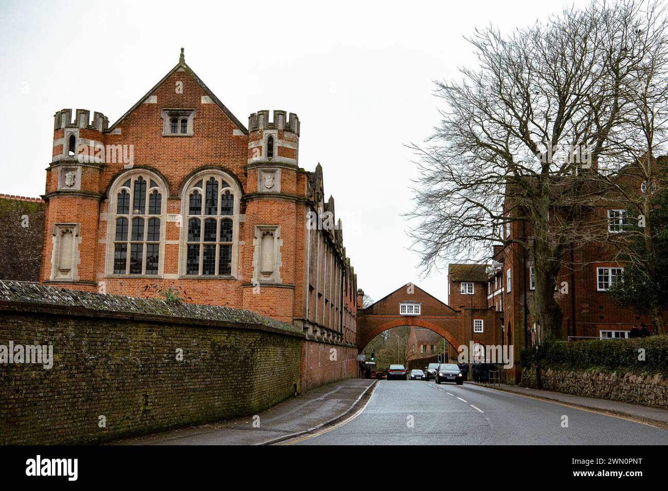 Marlborough college buildings private boarding and day school with archway across the road and traffic flowing underneath Wiltshire UK Stock Photo