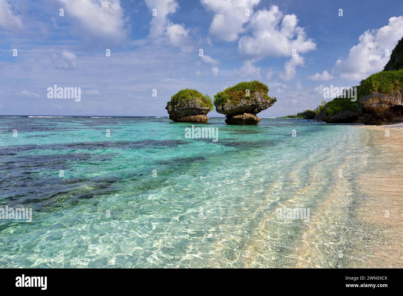 Clear warm waters and mushroom rocks at Tanguisson Beach, Guam Stock Photo