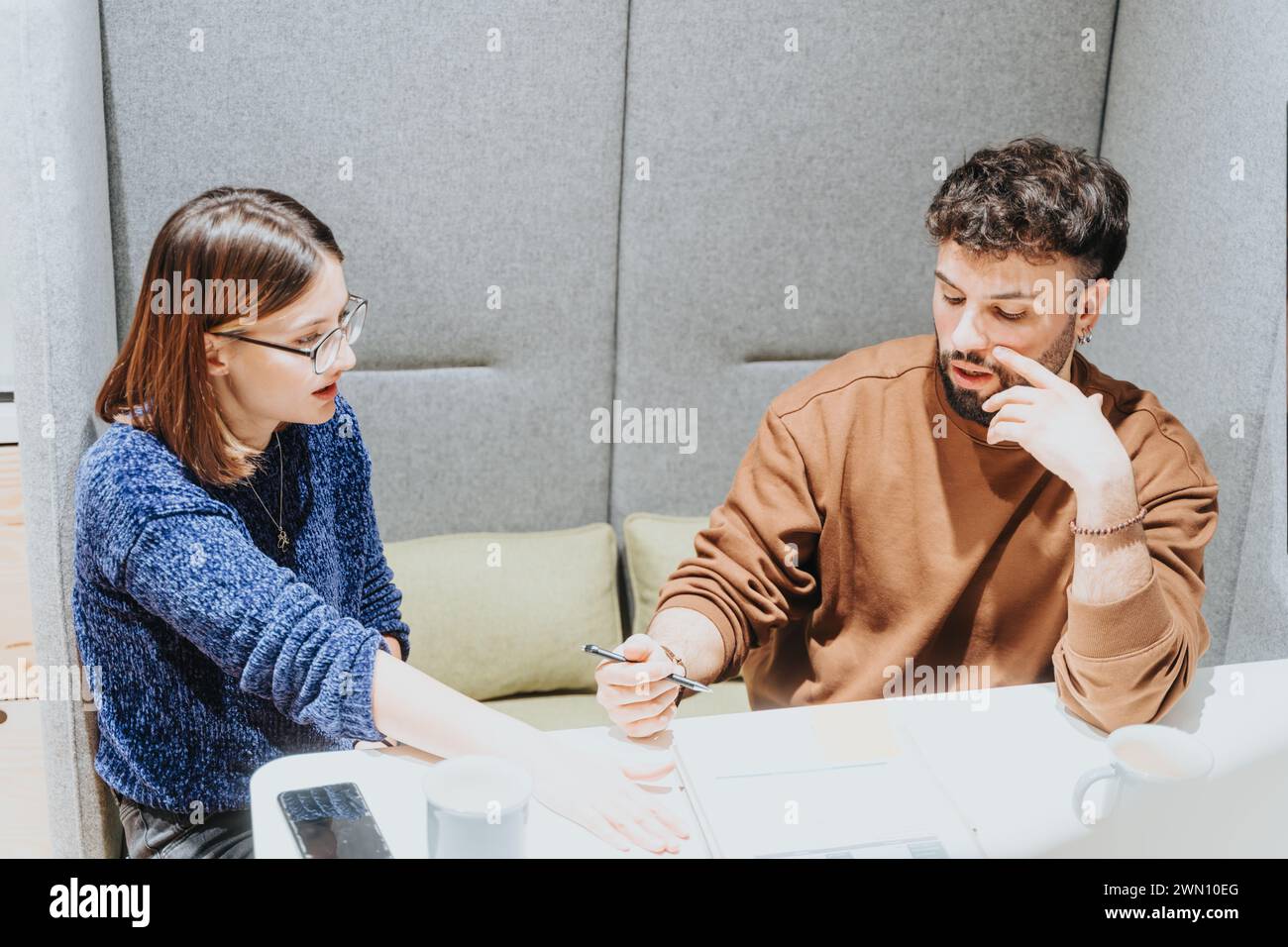 Focused colleagues discussing project strategy at modern office. Stock Photo