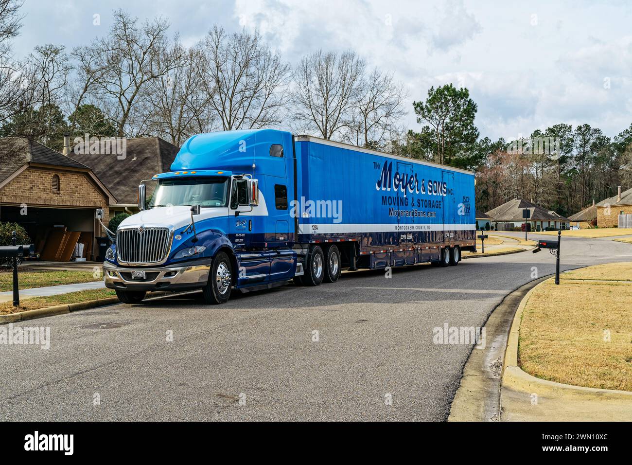 Large moving truck or van from Moyer and Sons moving company in front of a residential home in Pike Road Alabama, USA. Stock Photo