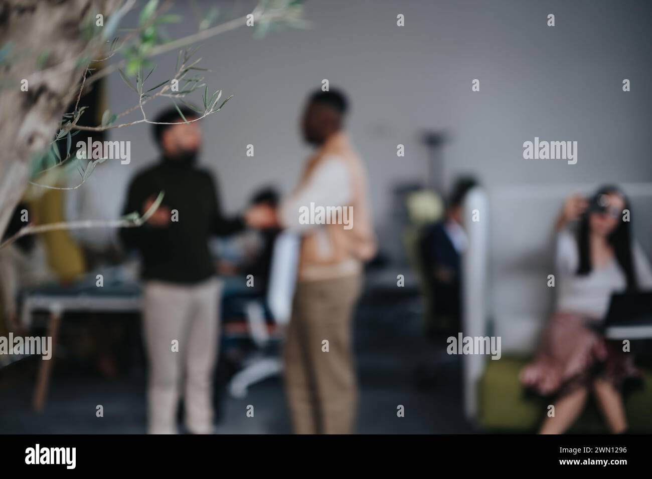 Multiethnic colleagues discussing reports, brainstorming ideas, and strategizing for business success. Stock Photo