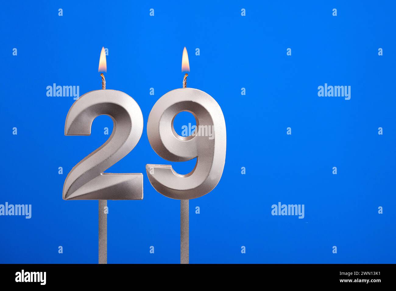 Birthday candle number 29 - Celebration card on blue background Stock Photo
