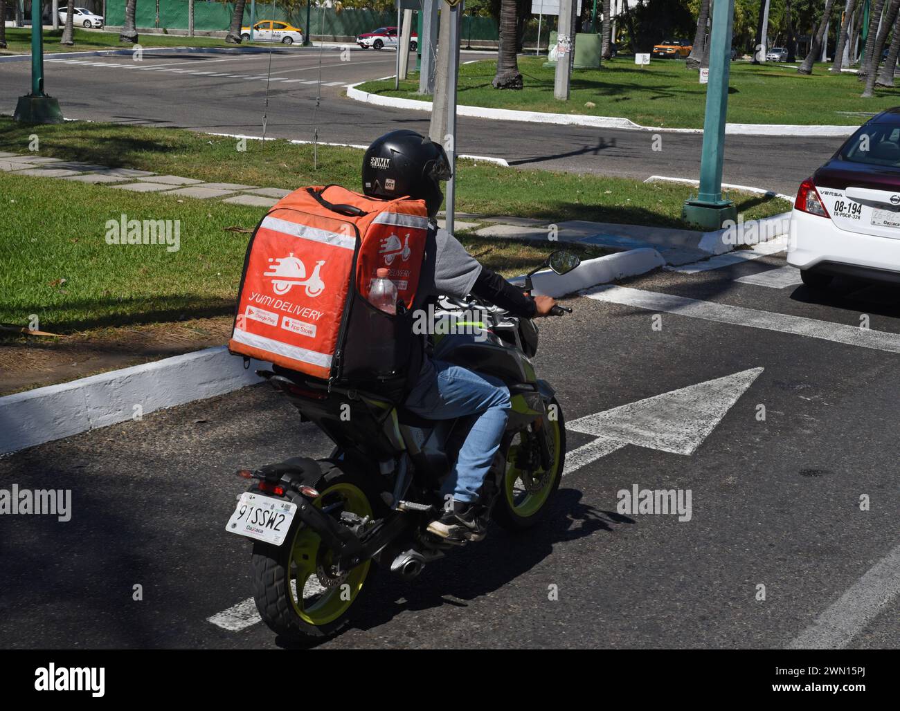 Food delivery service on a motorcyle in Huatulco, Oaxaca, Mexico Stock Photo