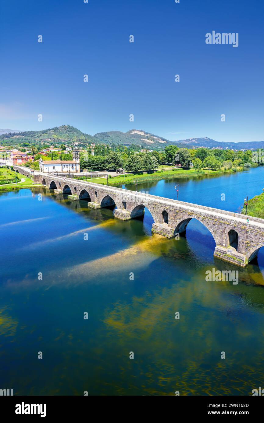 An elevated view of the beautiful medieval bridge crossing the River Lima, Portugal, which dates back to 1368. Stock Photo