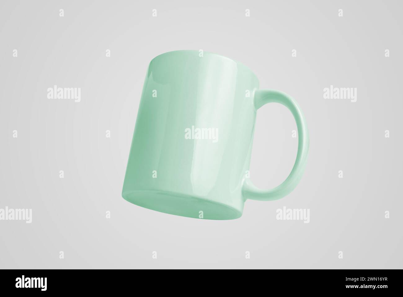 Green cup levitating, clean surface for logo or brand promotion Stock Photo