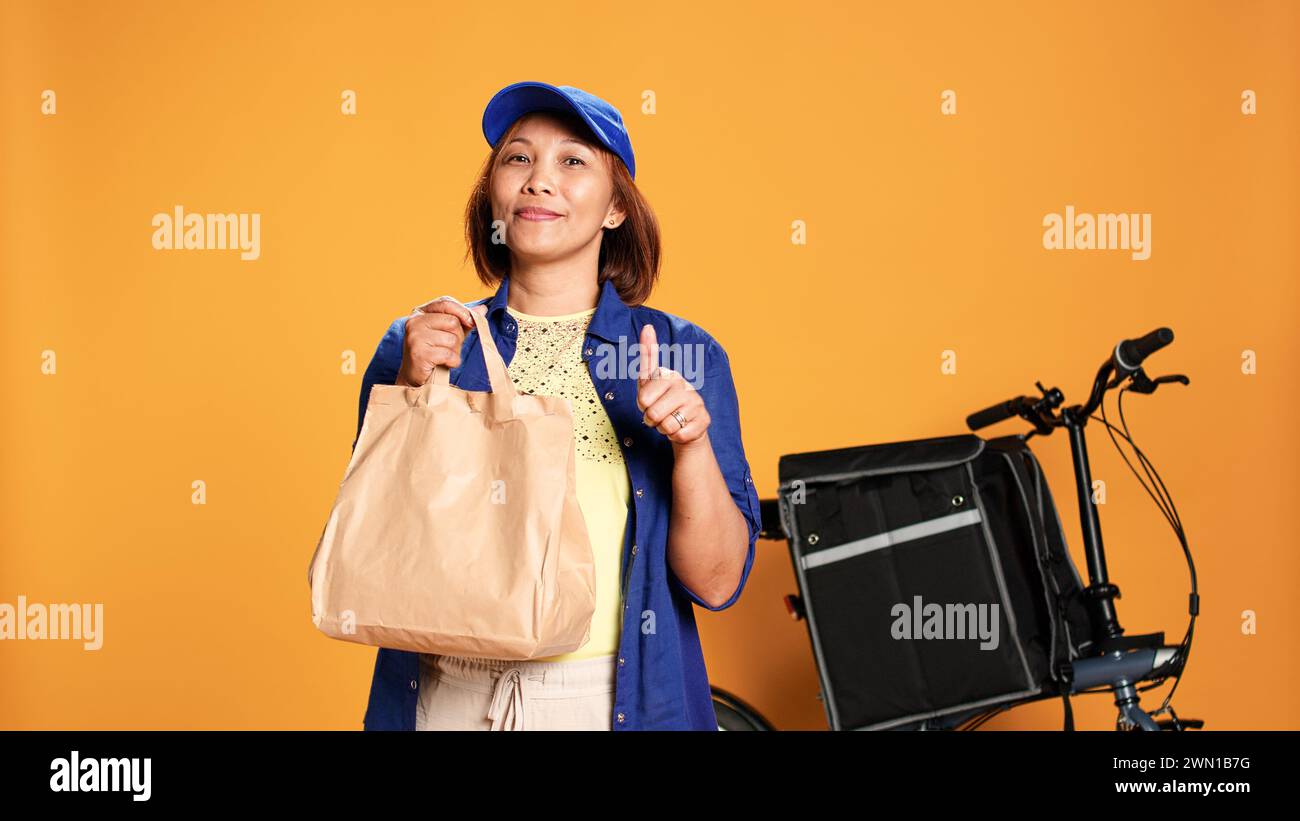 Slow motion portrait shot of friendly courier waiting for customer to ...
