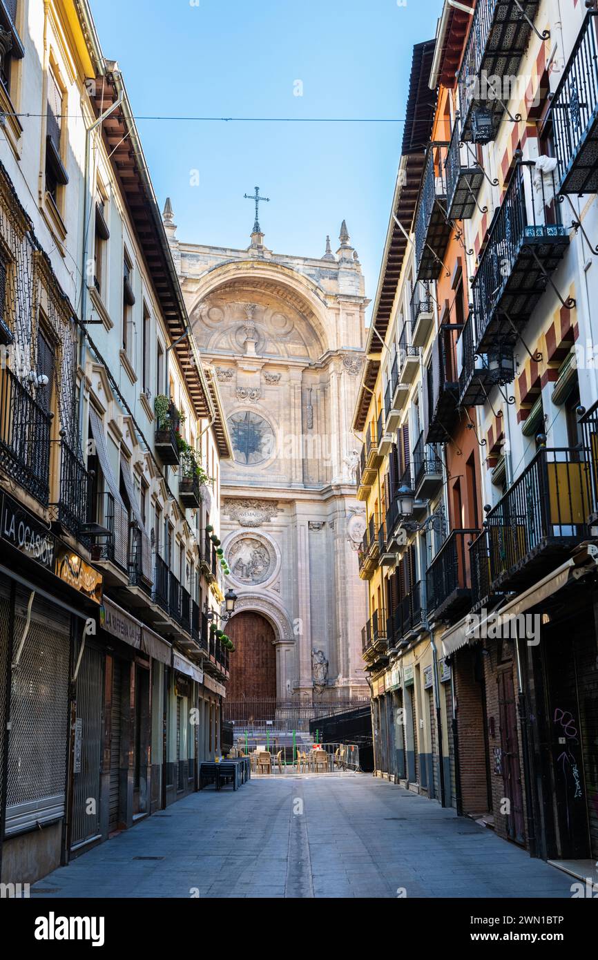 GRANADA, SPAIN: MARCH 25, 2023: Narrow street leading to the Cathedral in Granada. Stock Photo