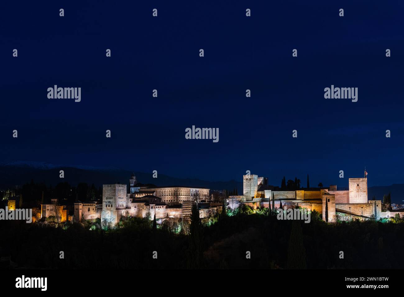 GRANADA, SPAIN: MARCH 24, 2023: Panorama view of the Alhambra in Granada on a clear Spring night, a palace and fortress complex that remains one of th Stock Photo
