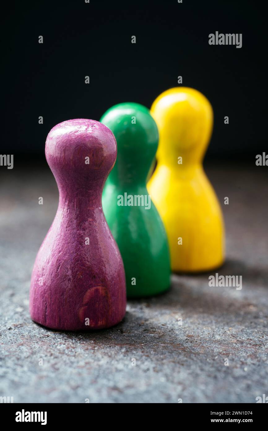 Three pawn-style playing pieces standing together. Stock Photo