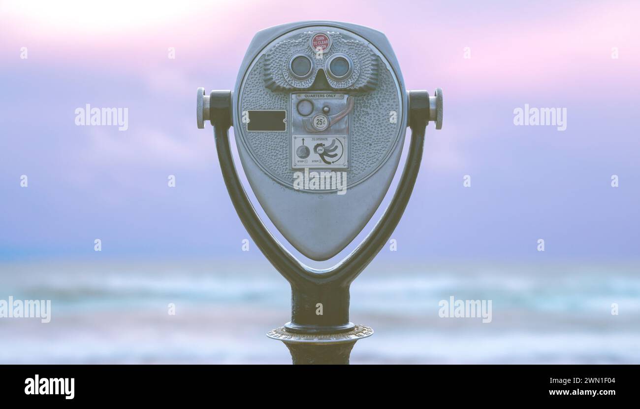 A Retro Coin Operated Tower Viewer Beside A Tropical Beach At Dusk Stock Photo