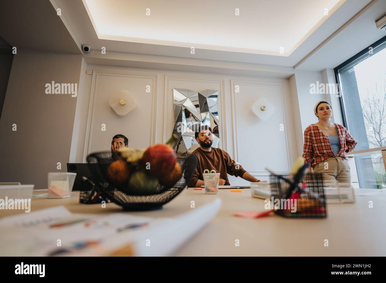 Creative team brainstorming in modern office space with bright lighting ...