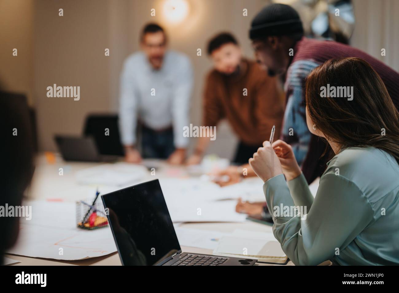 Multi generational, mixed race business team collaborating on project ...