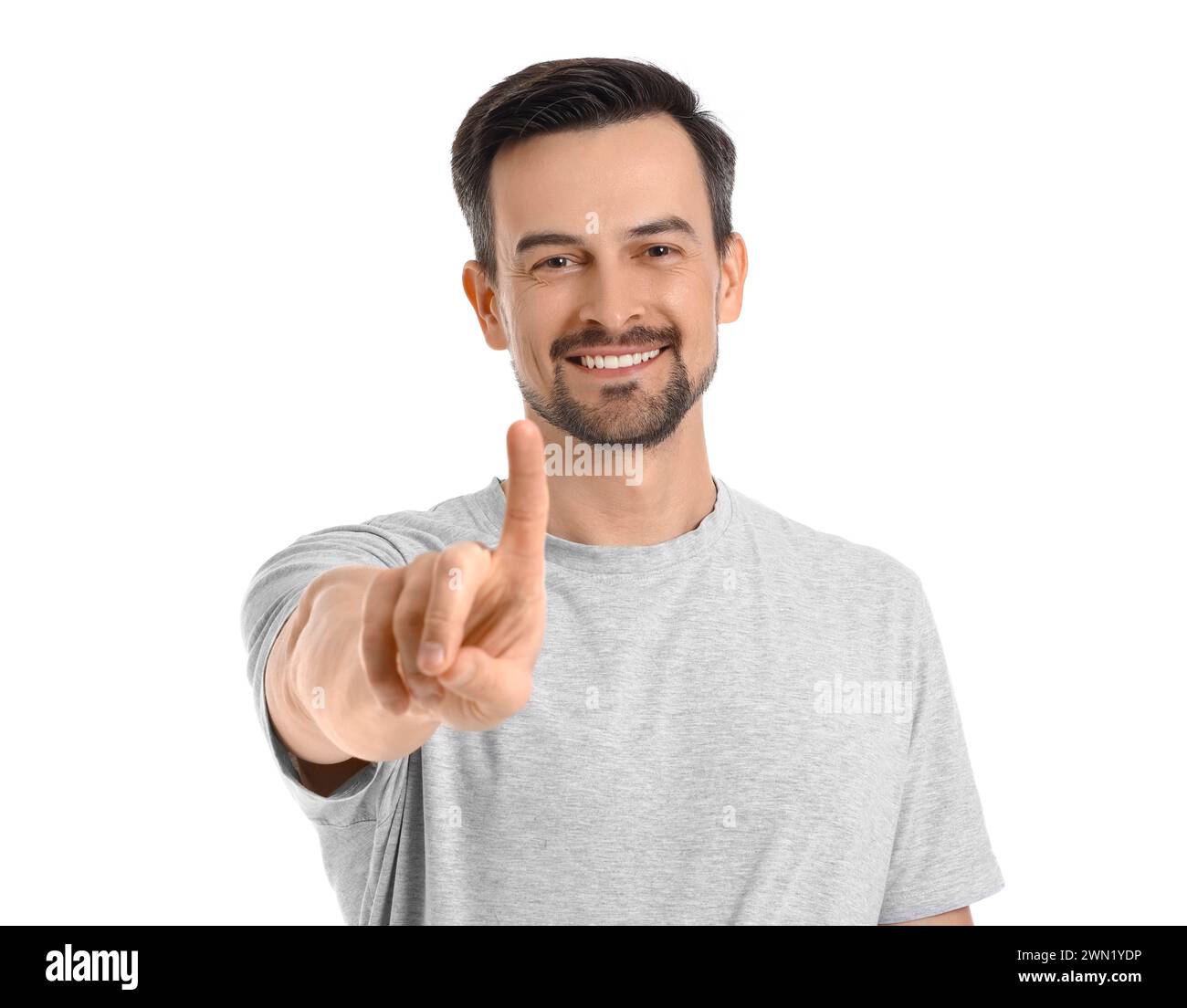 Handsome man using virtual screen on white background Stock Photo